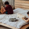 people with a dog on a bed