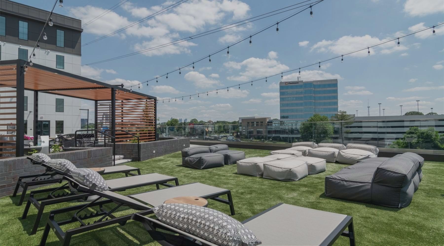 Pool lounge at our luxury West Midtown Atlanta apartments with string lights and lounge chairs