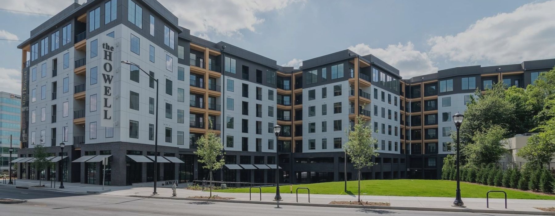 The Howell apartments exterior with wide grass space